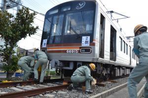 脱線した車両に資機材を設置している写真